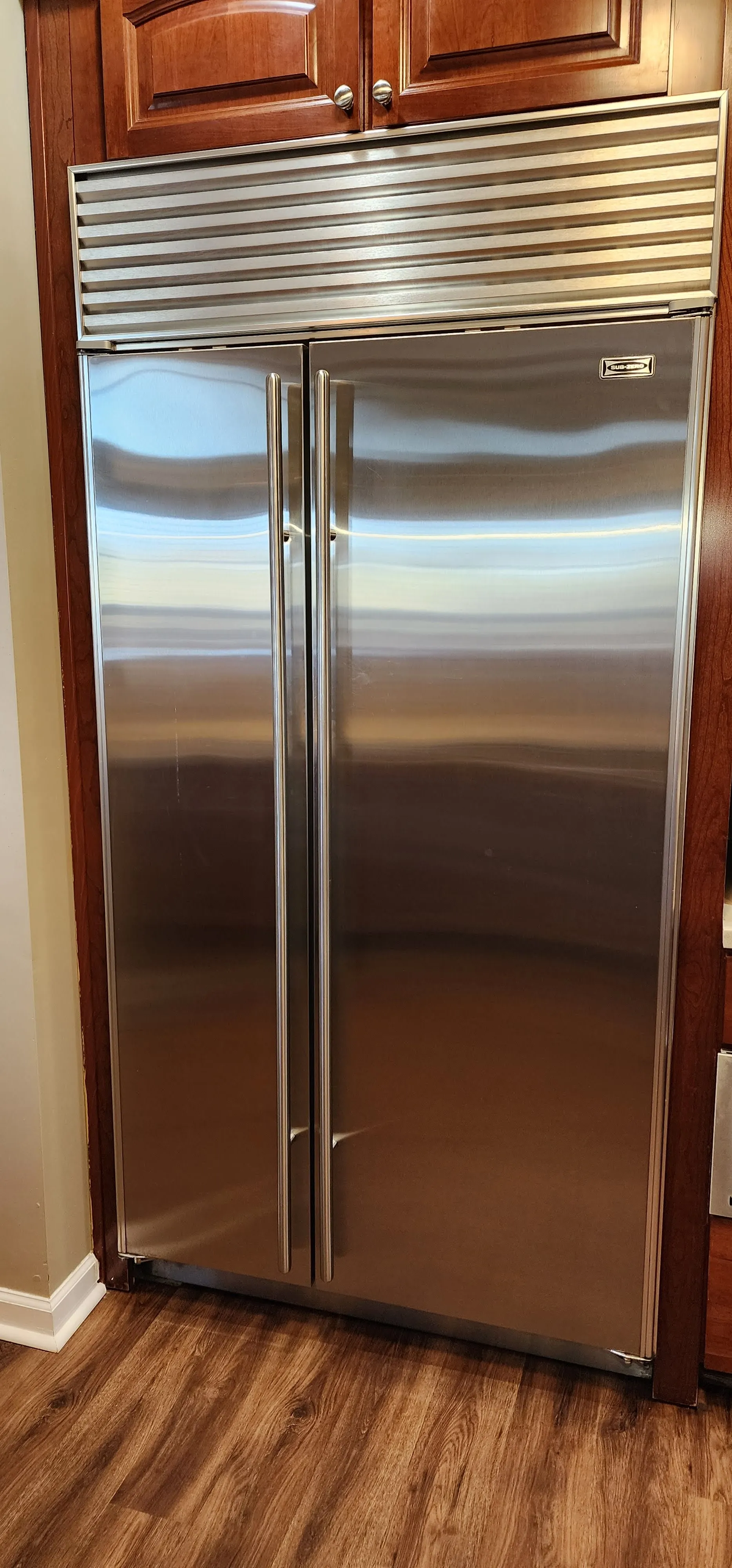 Built-in stainless steel refrigerator in a kitchen