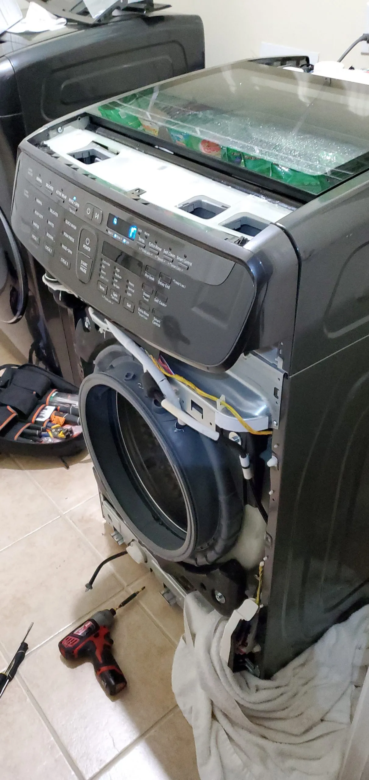 Front-load washer with its top panel removed for repair