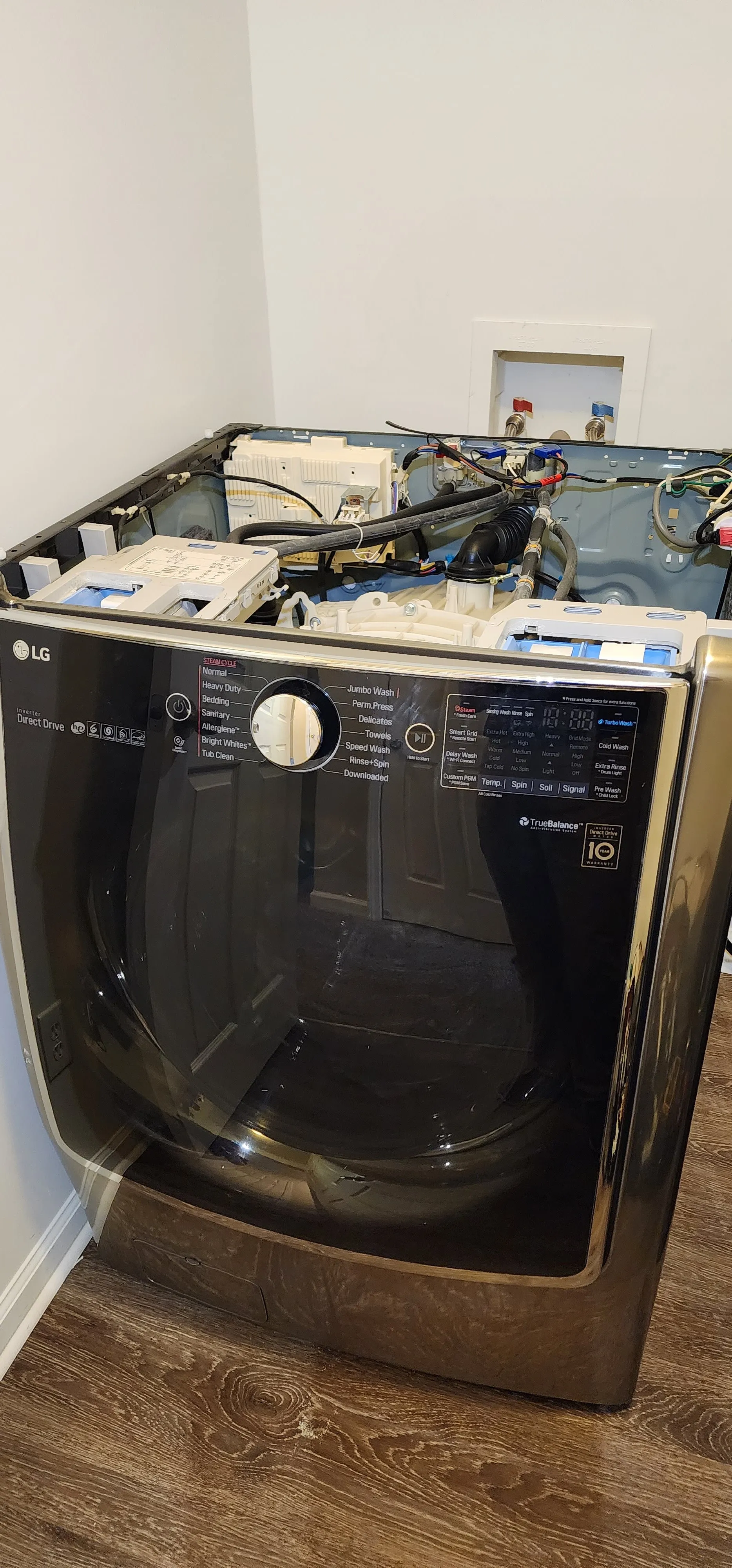 Front-load washer with its top panel removed for repair