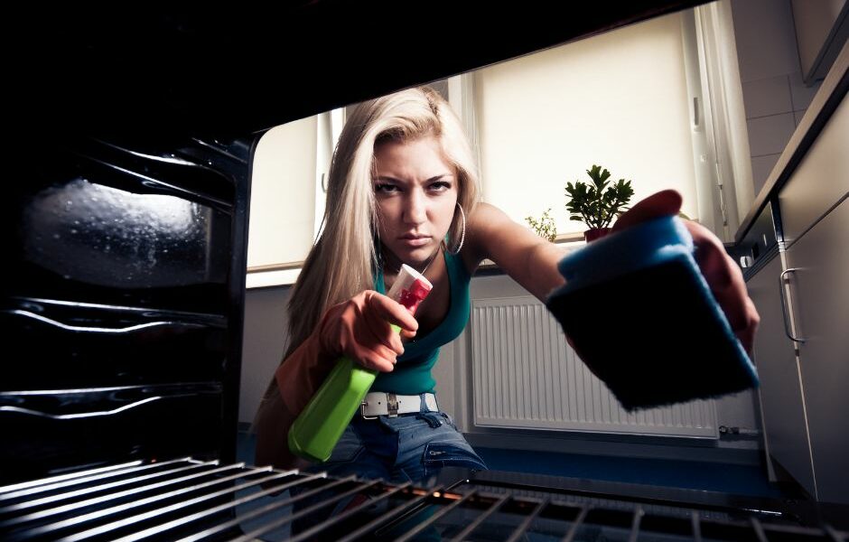 Self Cleaning Oven blog photo f a woman cleaning her oven with chemicals